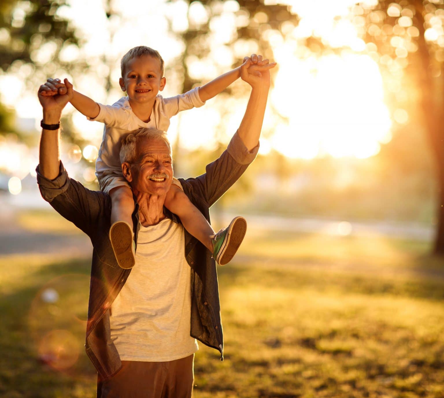patient after rhinaer treatment for runny nose Happy grandpa has grandson on his shoulders and is not experiencing a runny nose due to rhinaer treatment